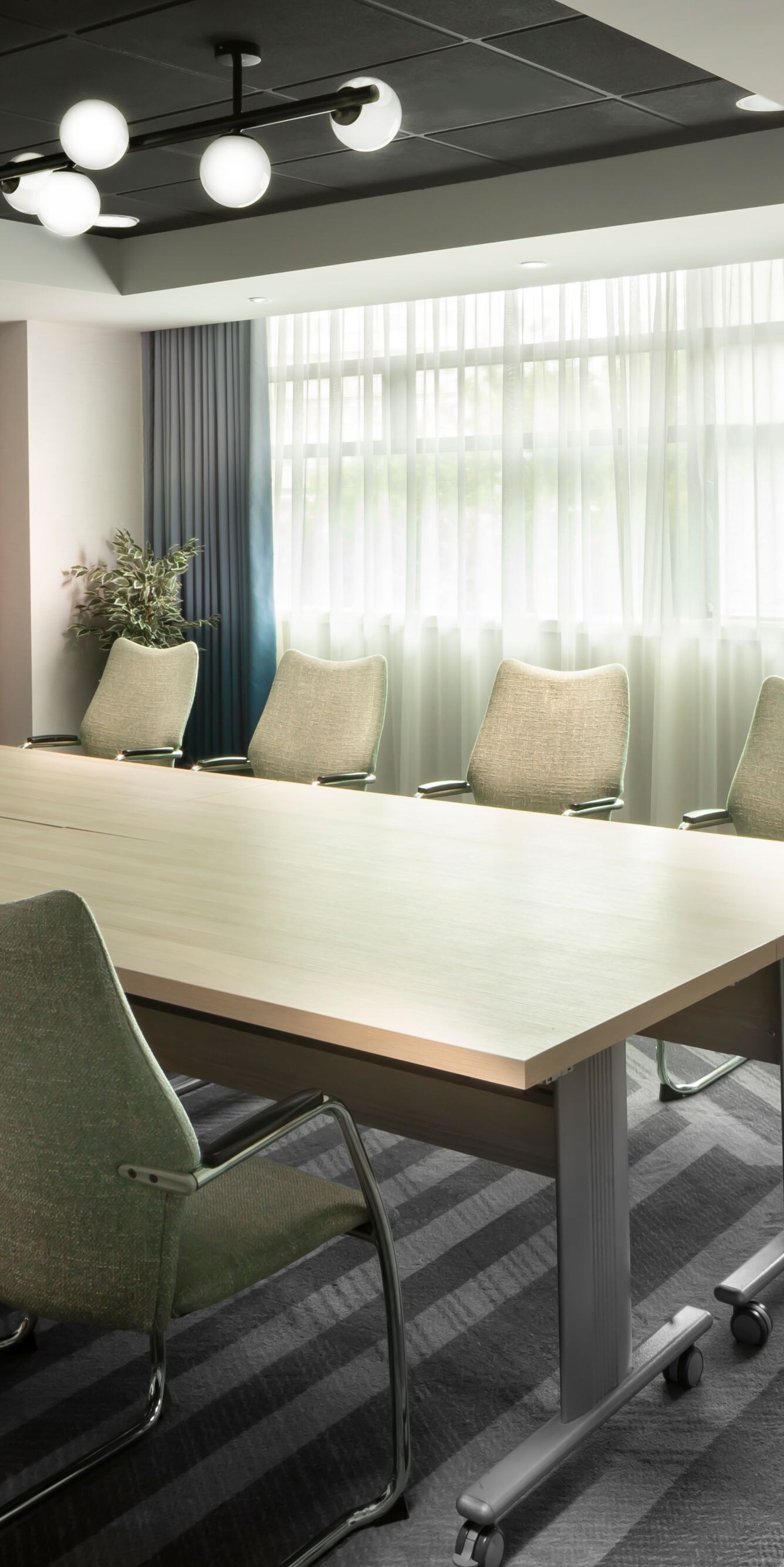 Modern boardroom with table, chairs and screen