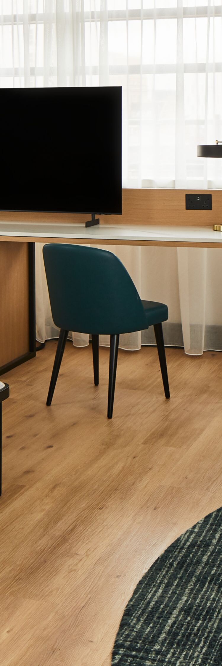 Panoramic suite with seating area, desk & TV.