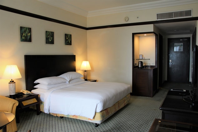 Wide view of deluxe bed in a hotel room.