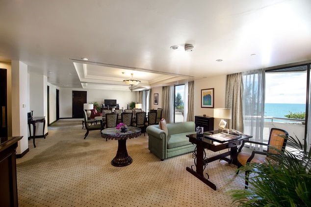 Wide view of a hotel room living room suite.