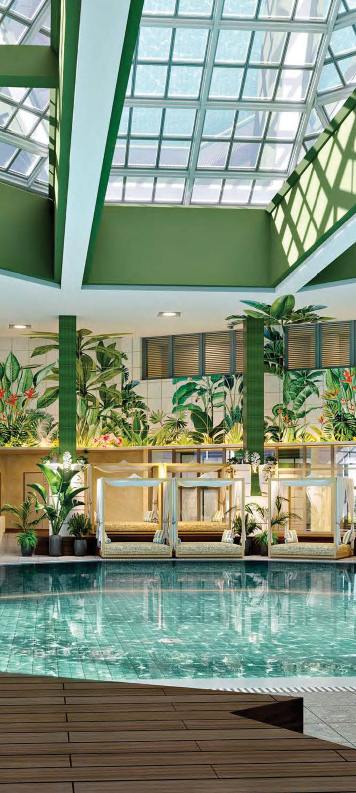Indoor pool with lounge chairs and tropical plants