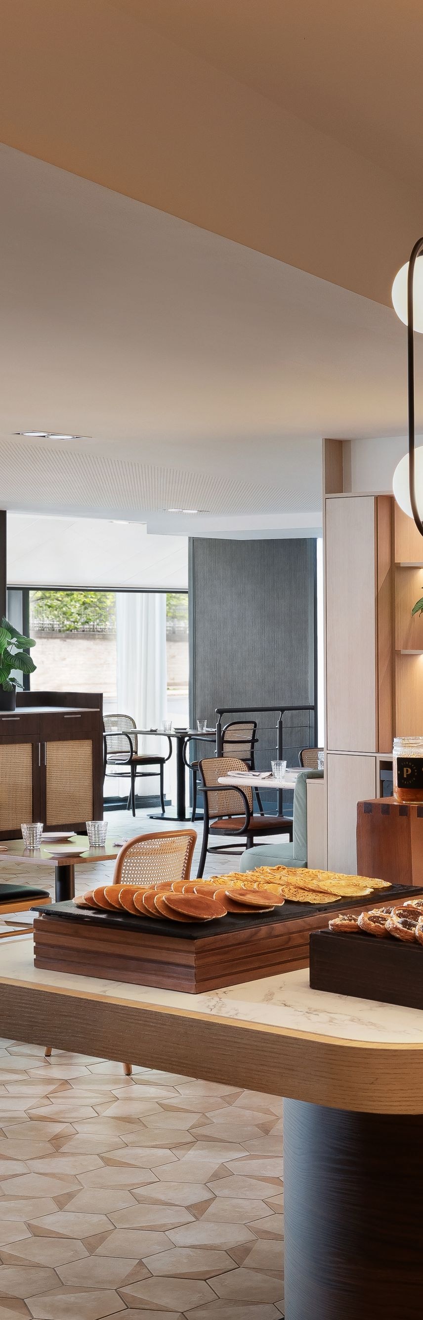 Breakfast buffet with pastries and dining tables