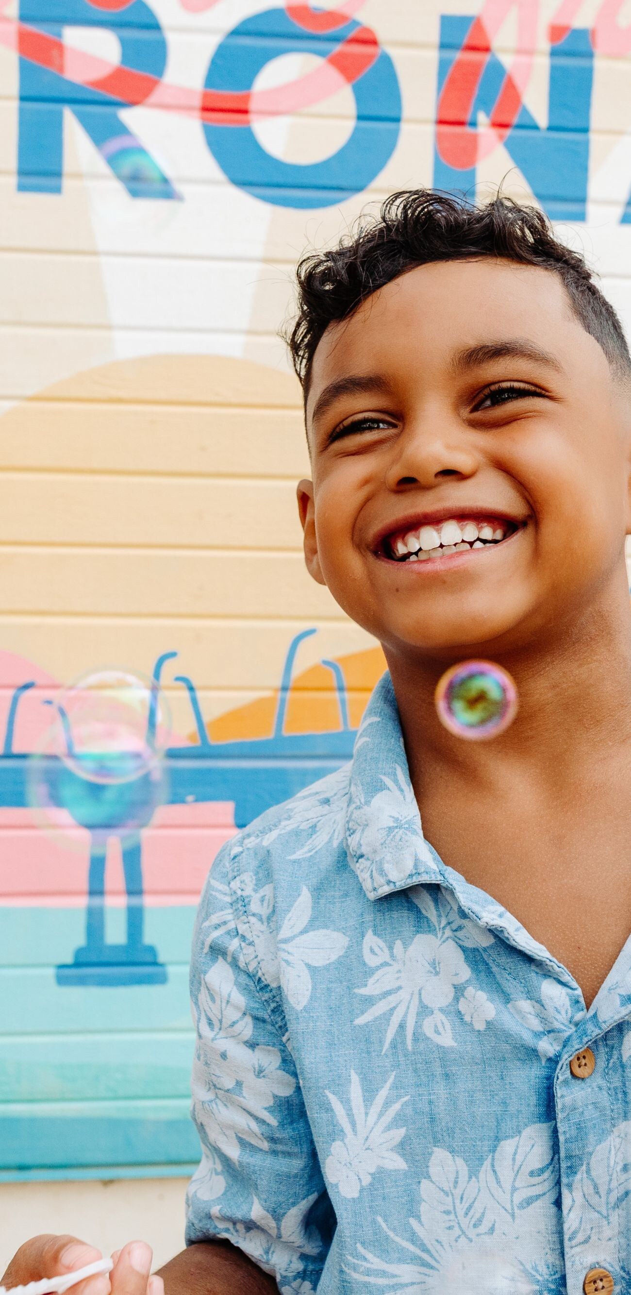 kid laughing with bubbles 