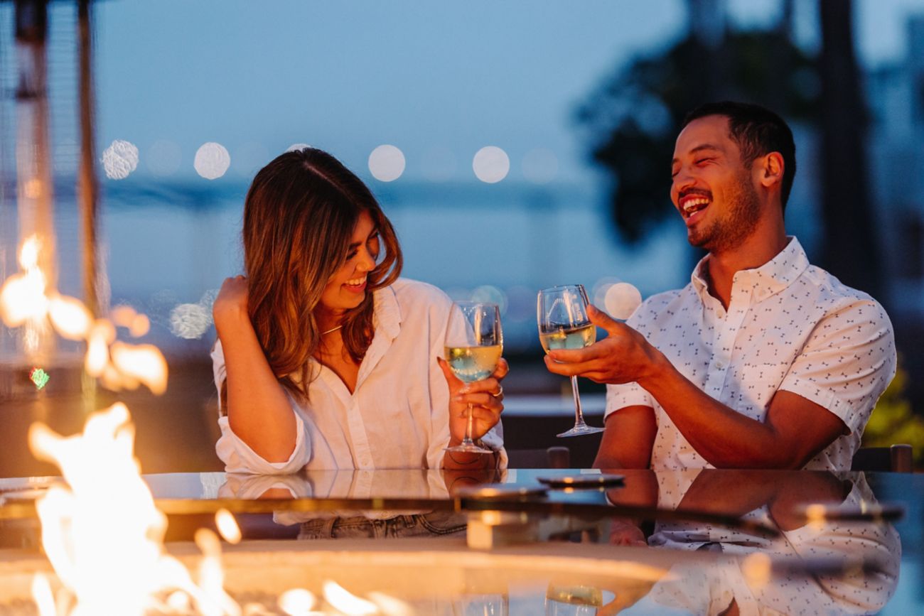 Couple enjoying drinks by firepit