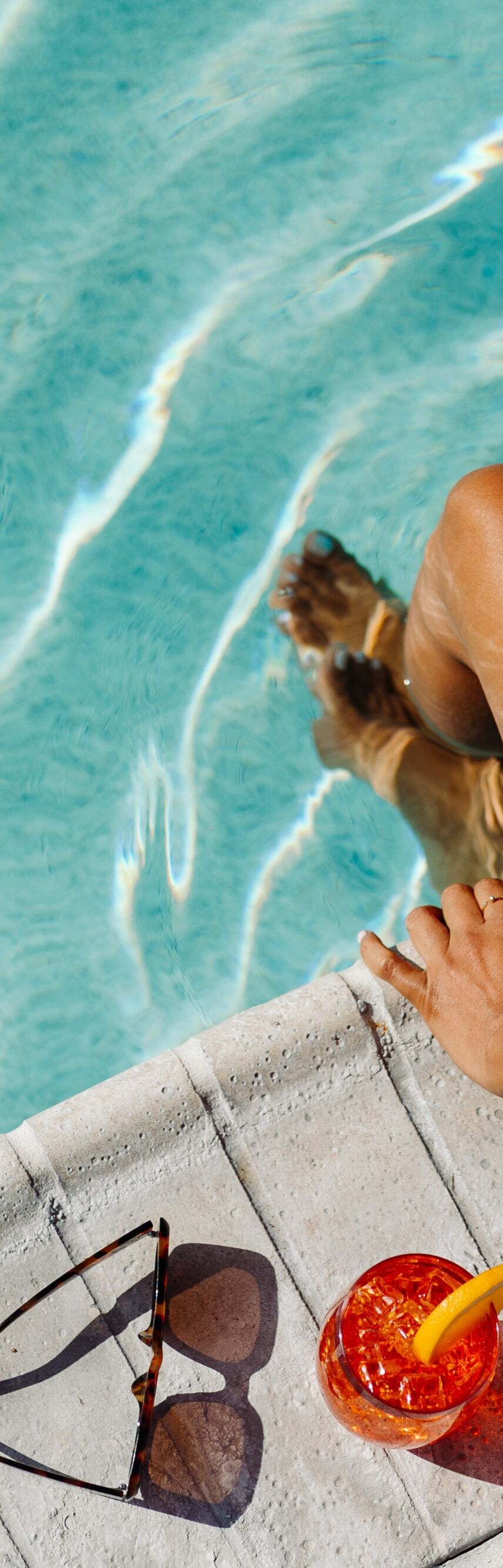 Woman sitting by pool 