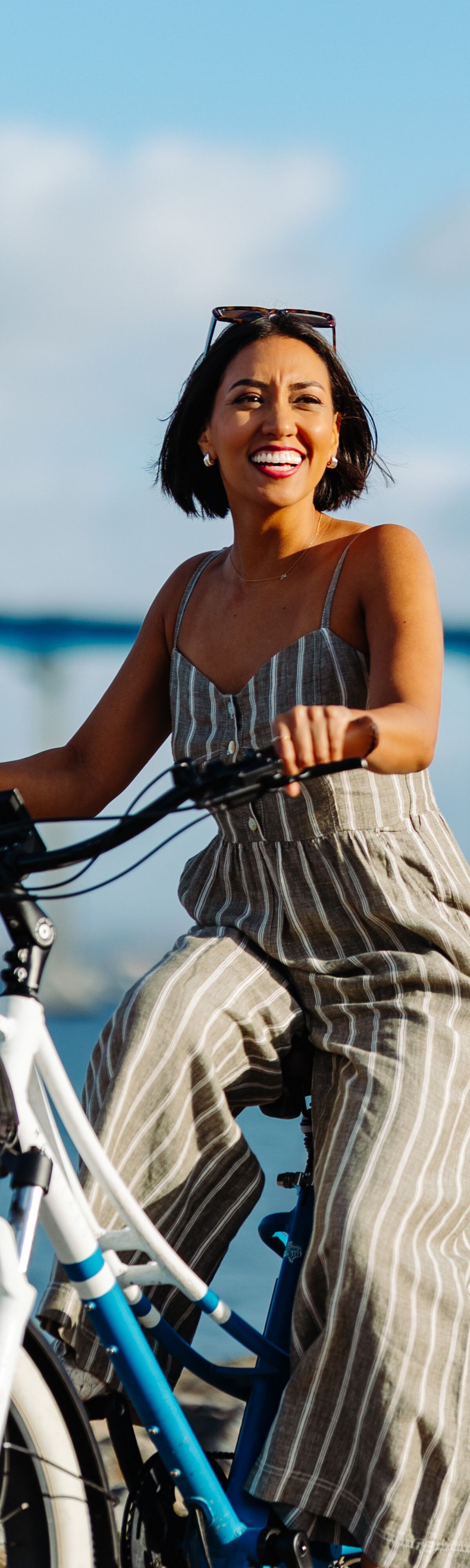 gal on bike in front of bridge 