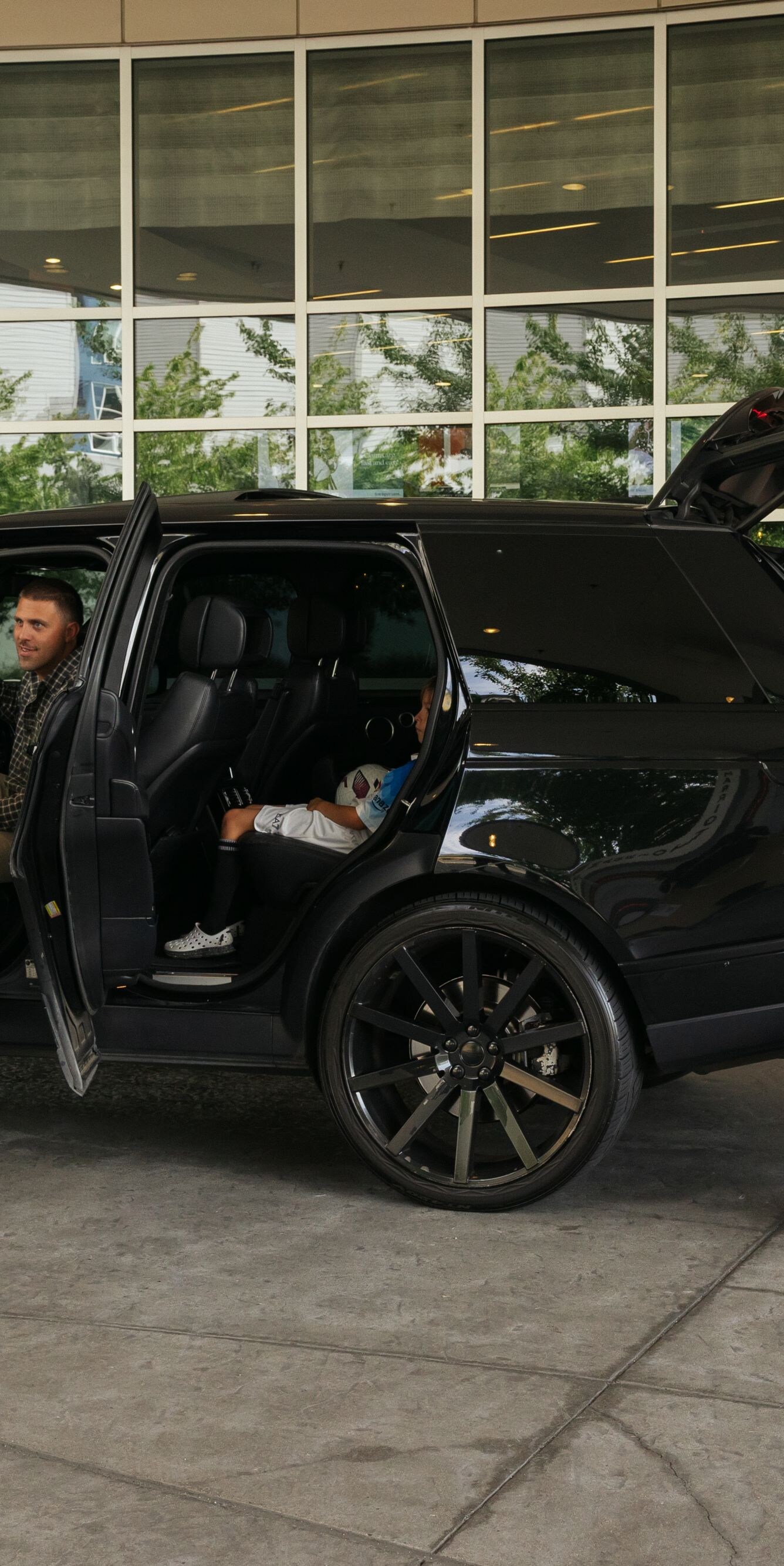Family arriving at entrance with valet