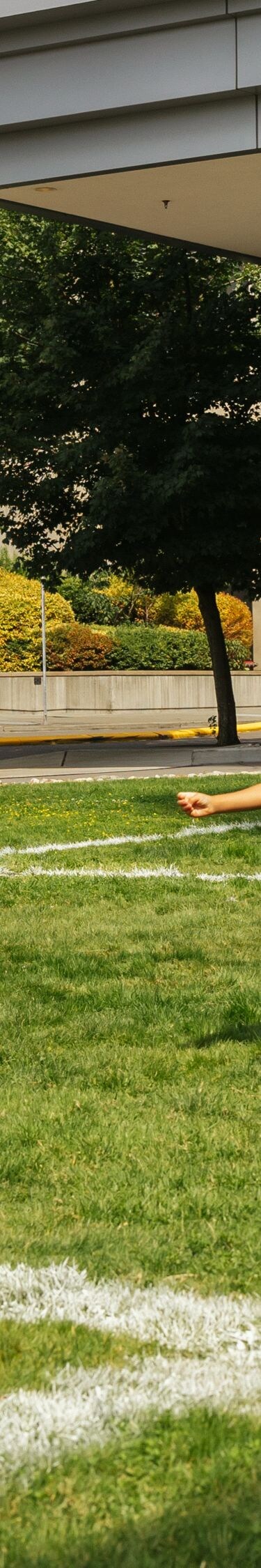 Children playing soccer on outdoor lawn