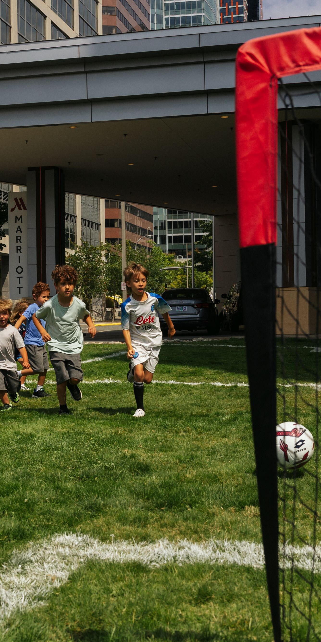 Children playing soccer on lawn