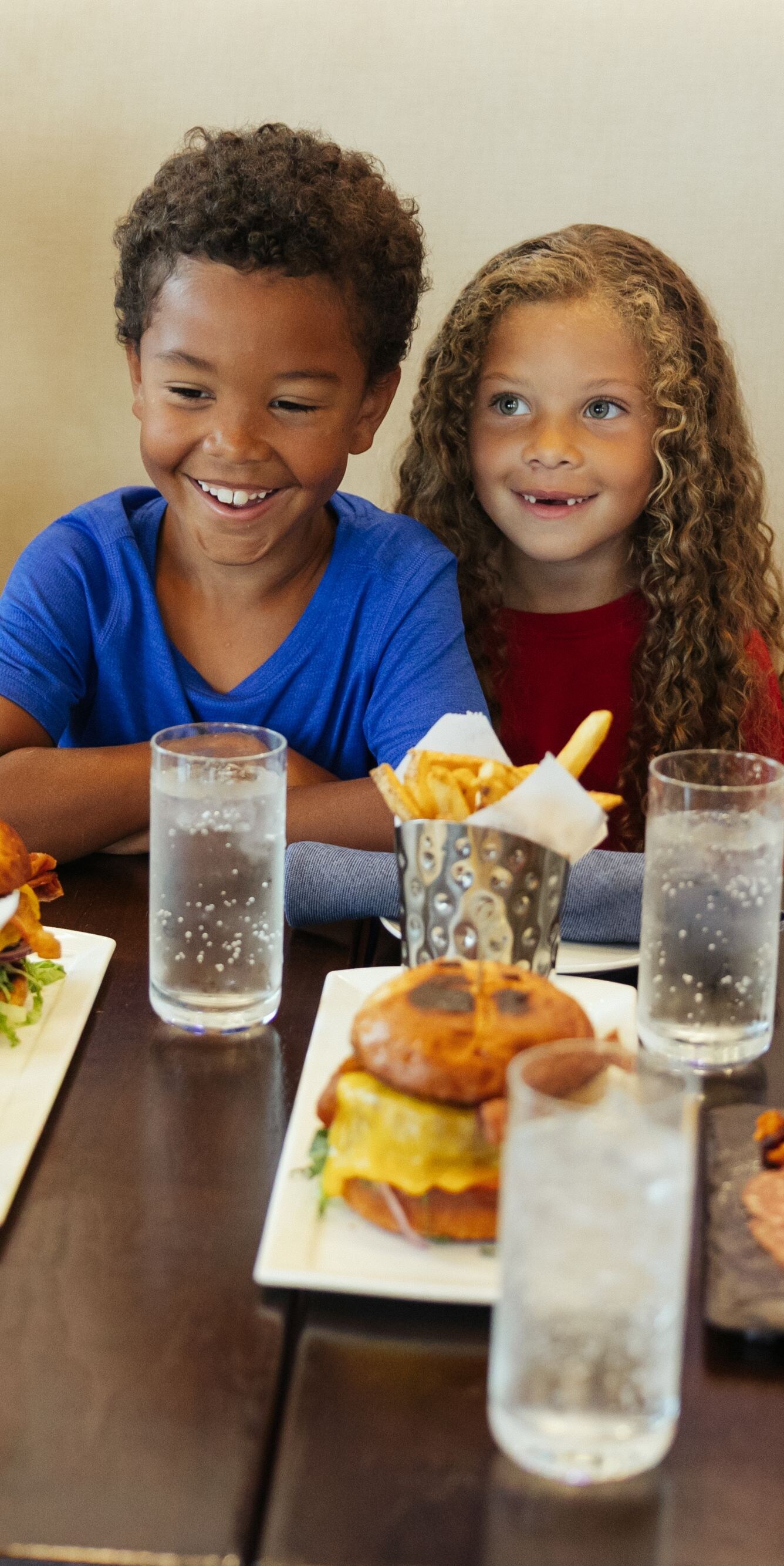 Children eating burgers and fries