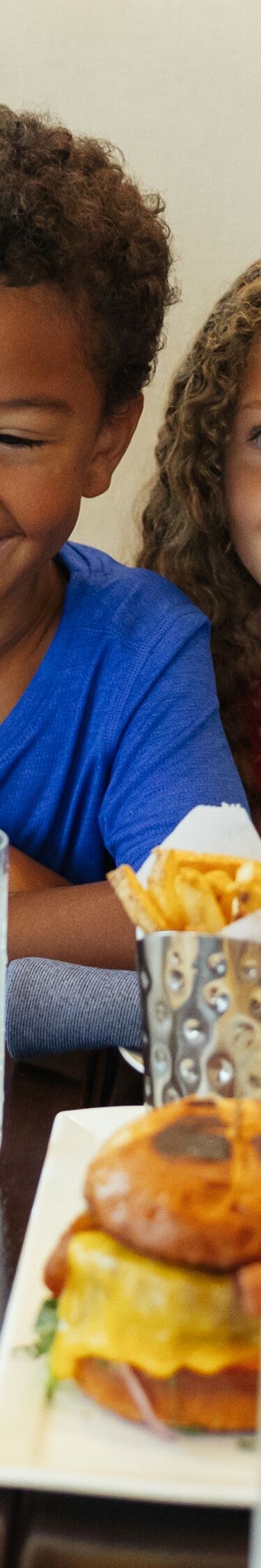 Children eating burgers and fries