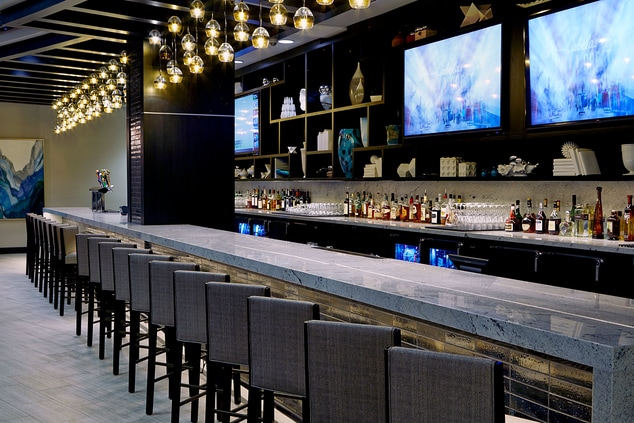 Bar with stools and TV screens