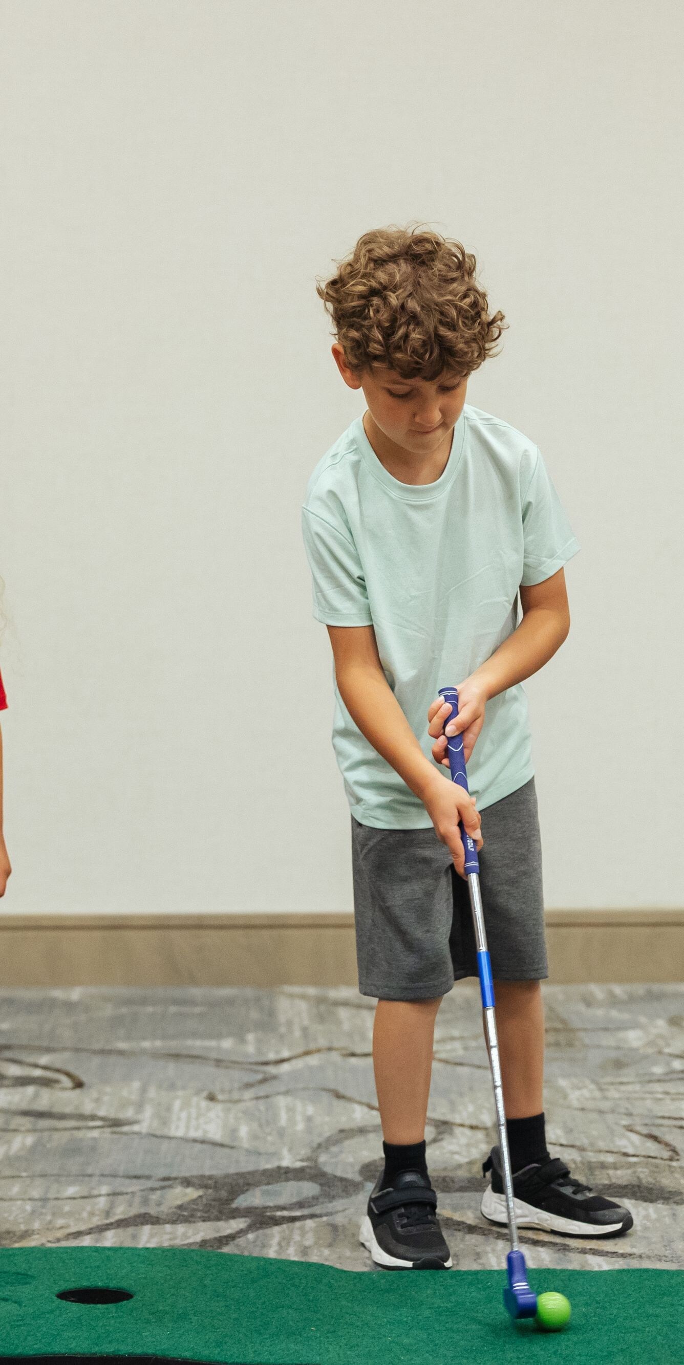 Children playing indoor mini golf