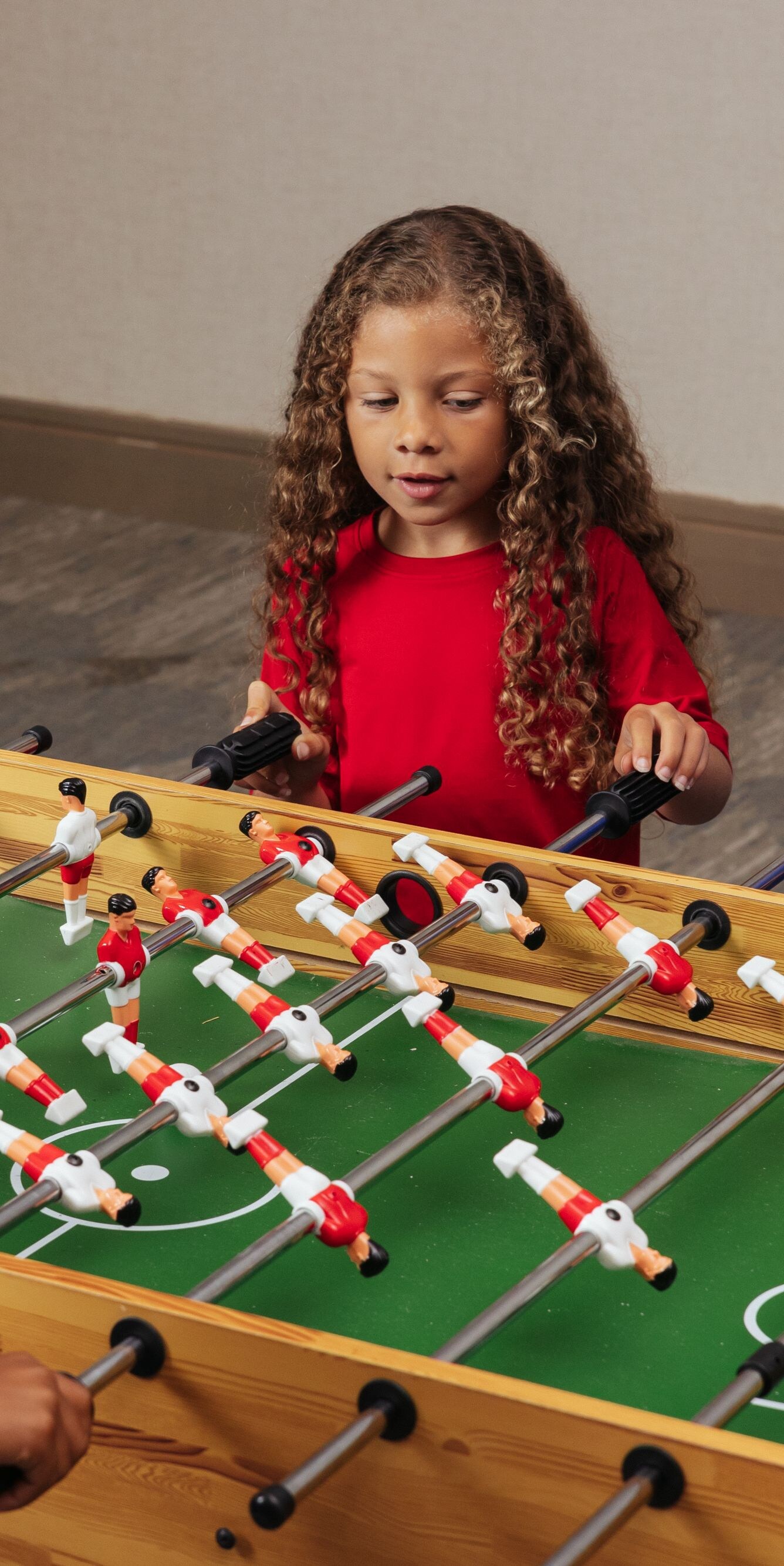 Children playing foosball in game room