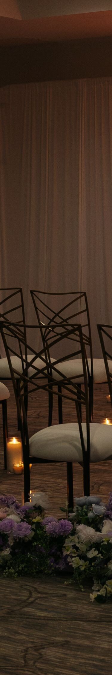 Wedding venue with rows of chairs and candles