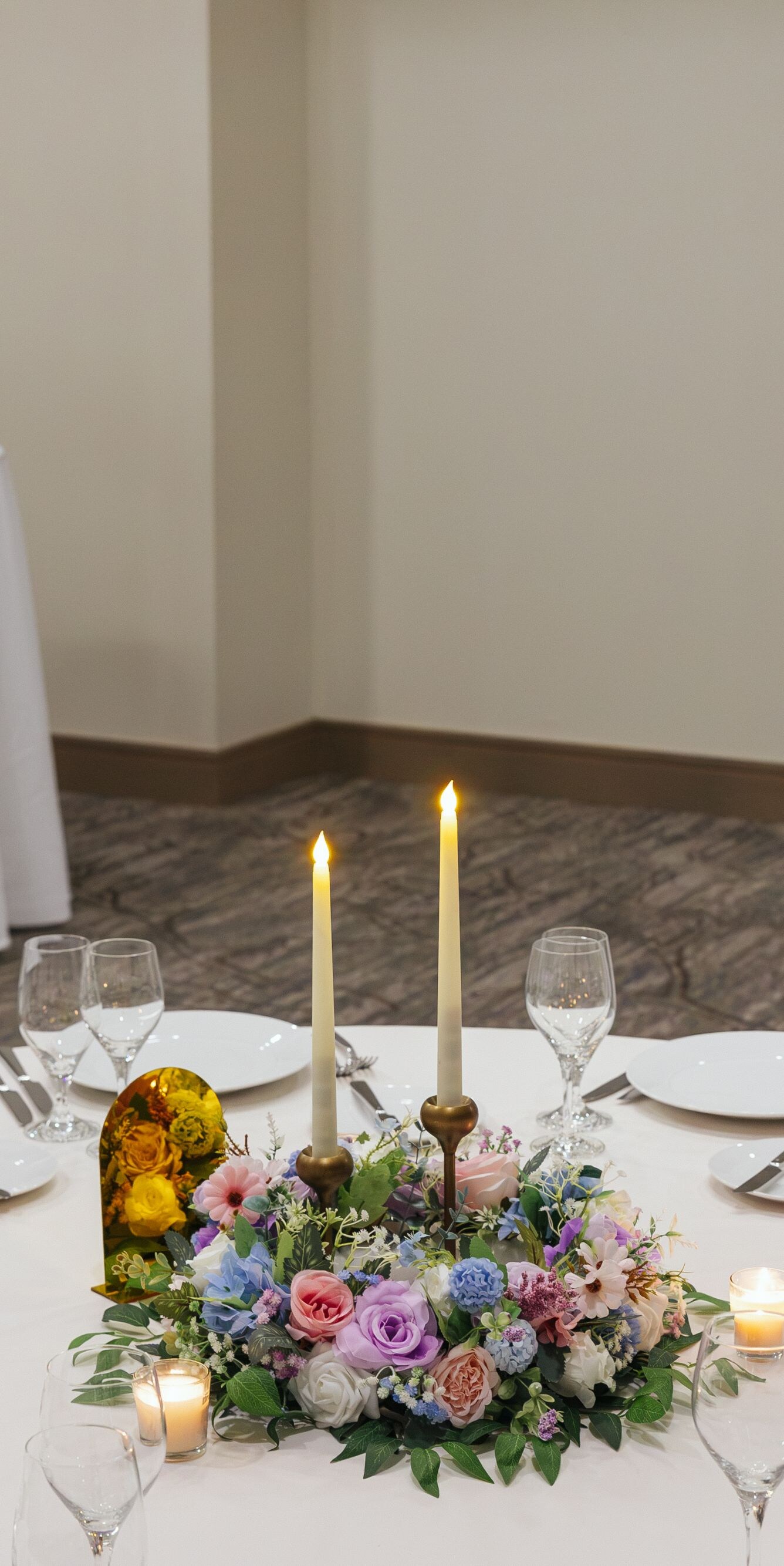Round table with floral centerpiece and candles