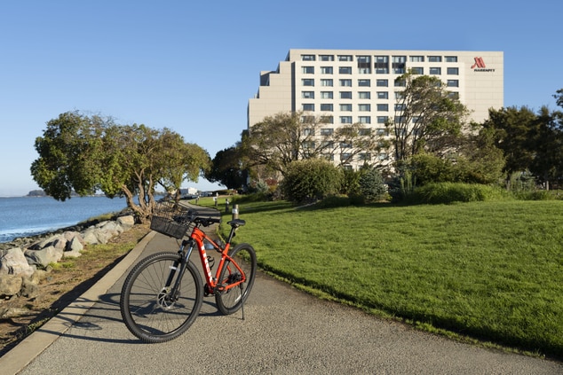 Bike on trail with hotel and trees in background