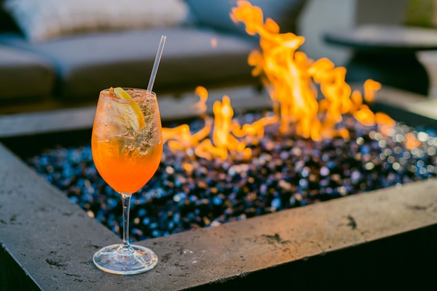 Drinks sits on edge of fire pit table