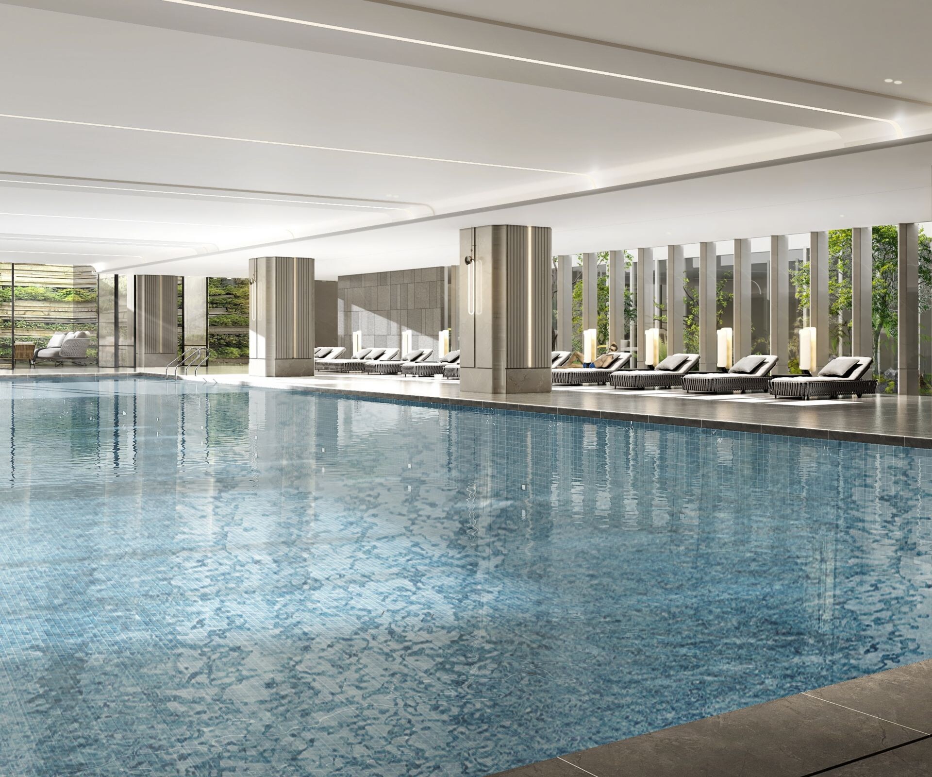 Indoor pool with lounge chairs and greenery