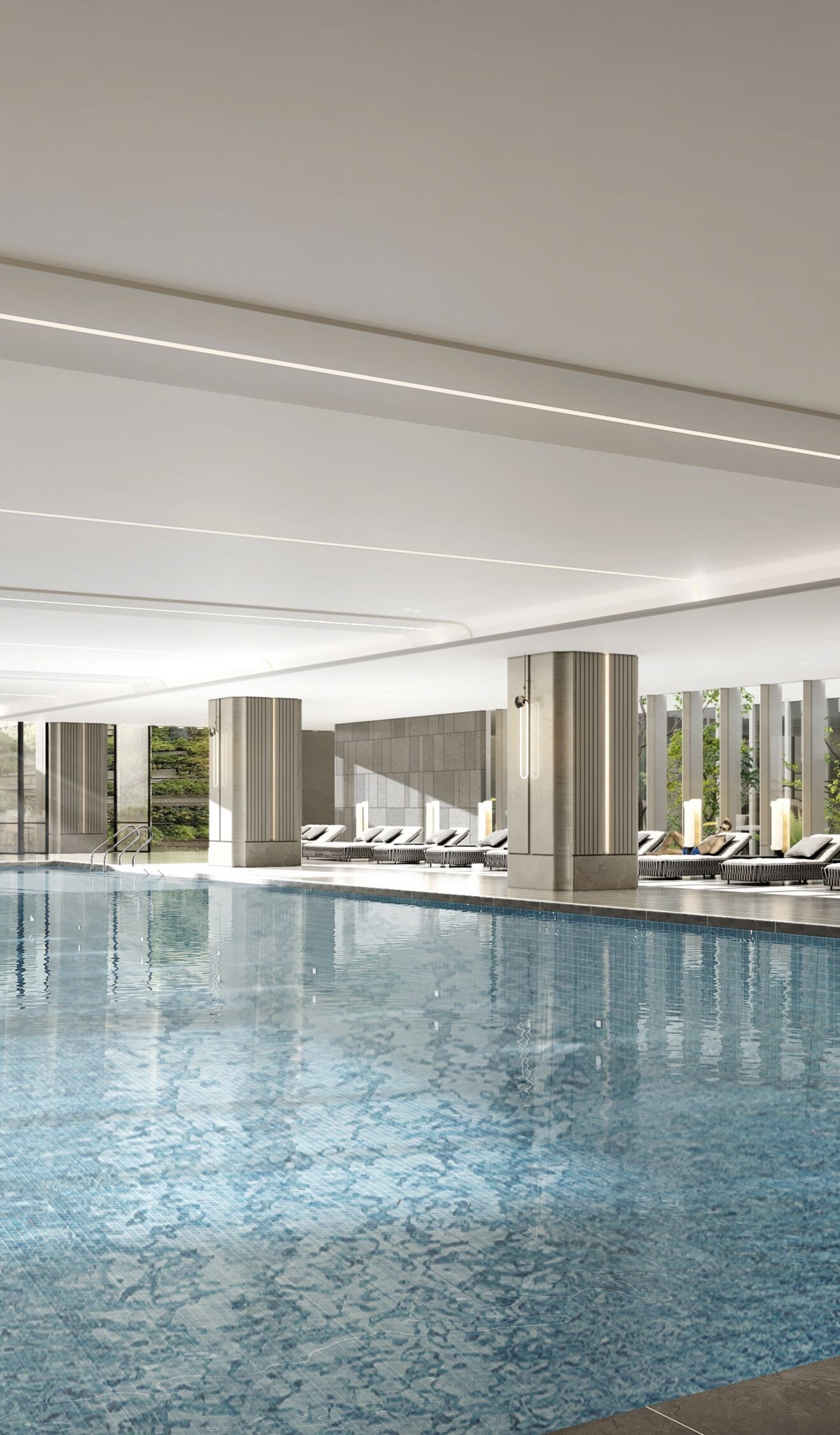 Indoor pool with lounge chairs and greenery