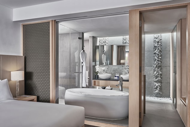 En-suite bathroom with bathtub and double sink
