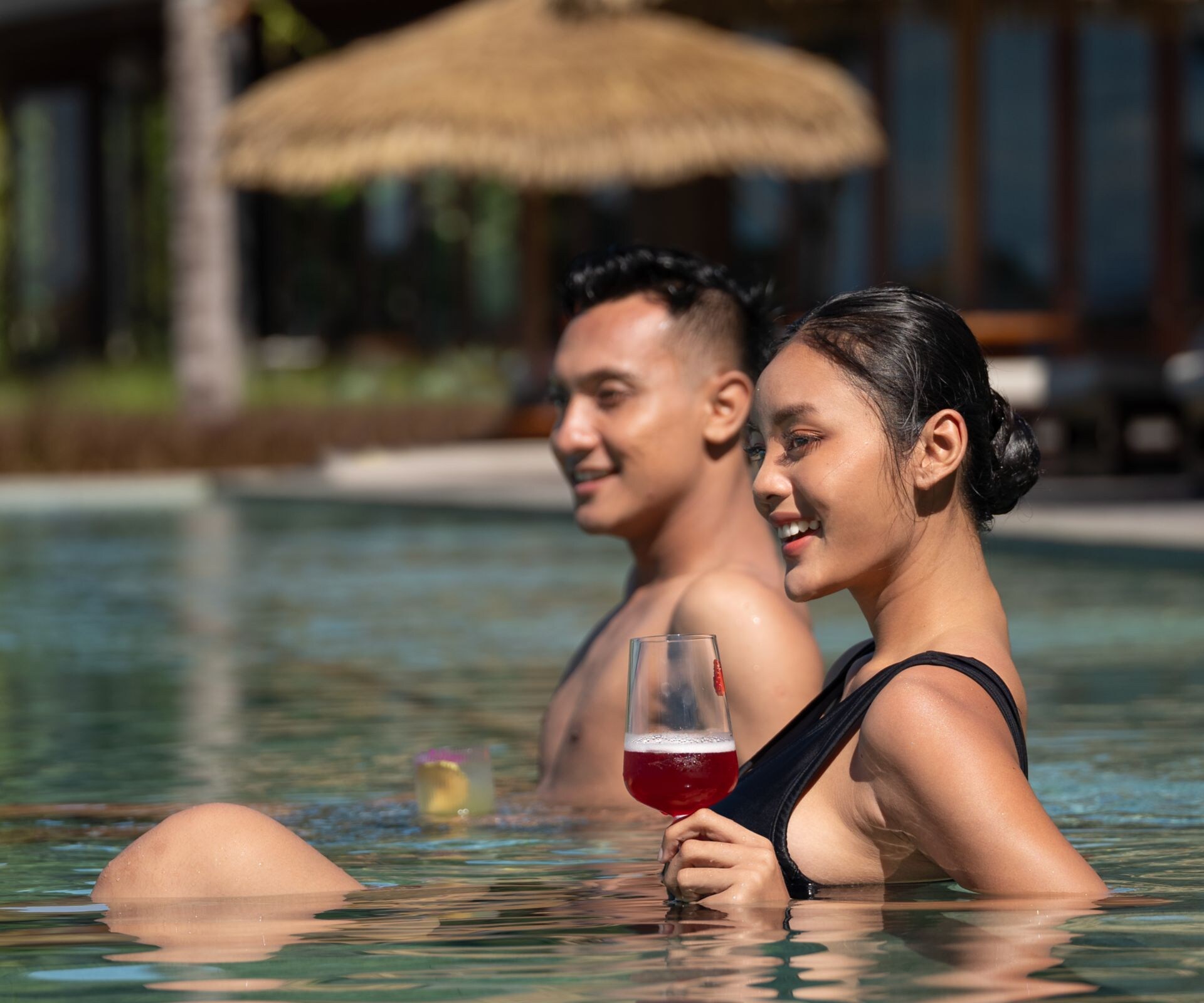 Man and woman enjoying a resort pool.