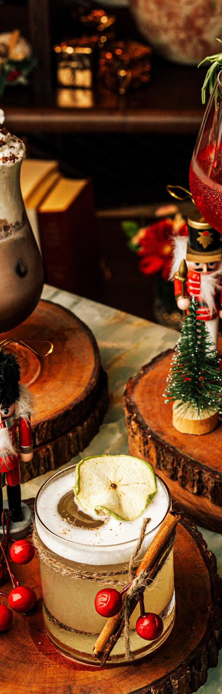 Three festive Christmas cocktails on wood stands