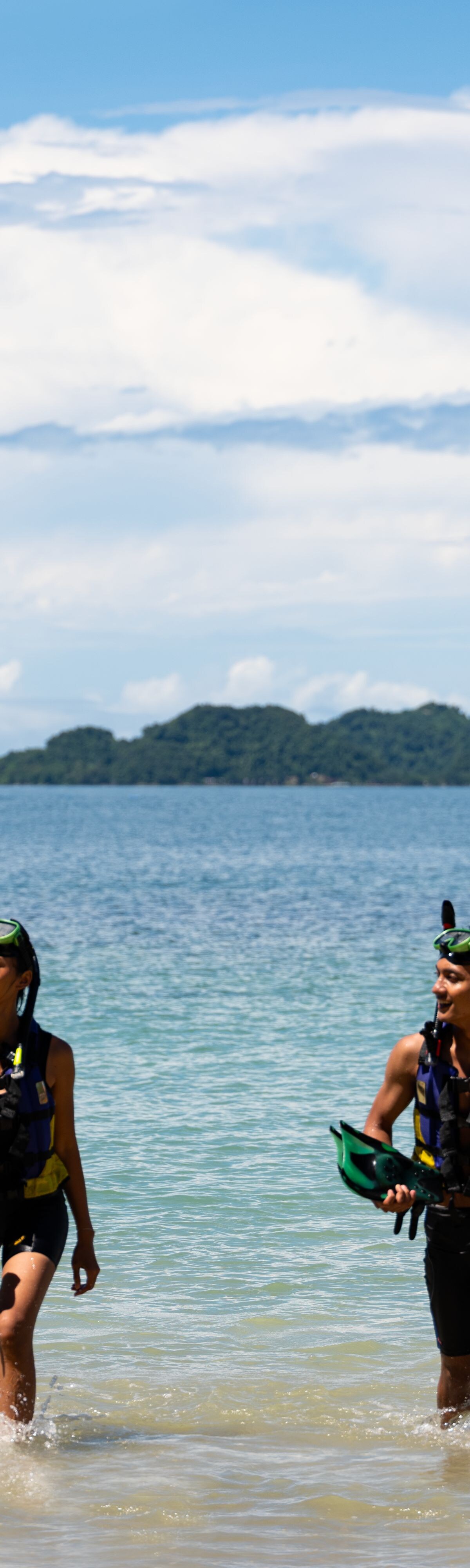 A couple going snorkeling in the water.