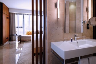 الحمام وغرفة المعيشة المتصلان في جناح لا سويت (La Suite)  