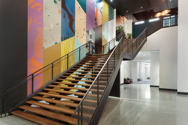Staircase with a mural on the left wall