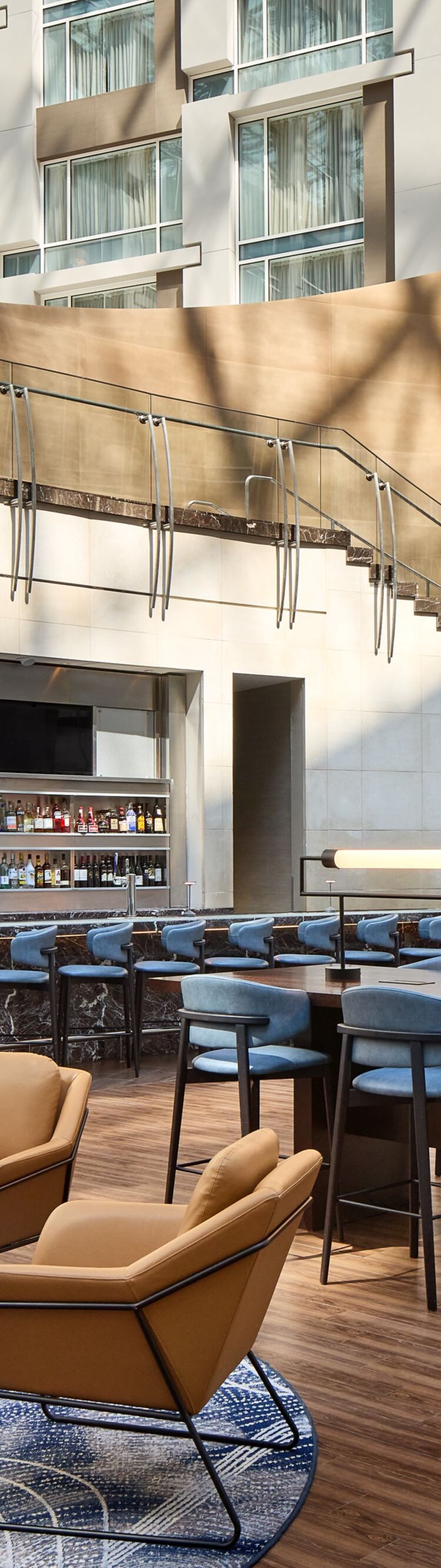 Modern bar with seating and atrium view