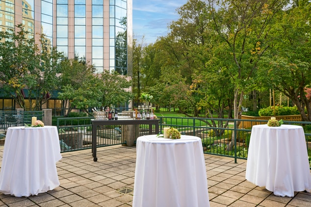Outdoor reception surrounded by lush greenery and 