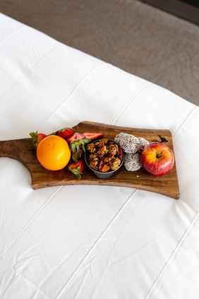 A board tray with fruit and nuts