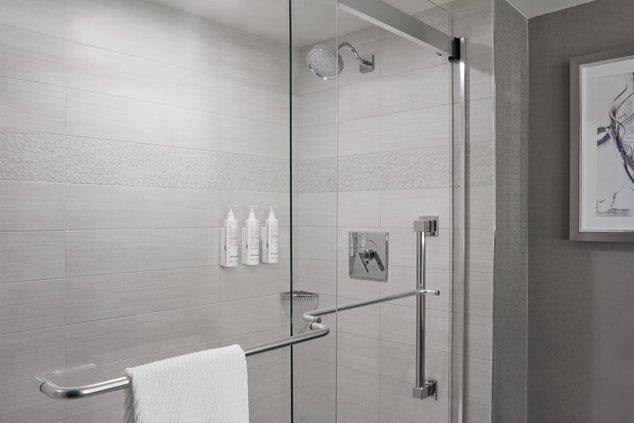 Standup glass shower with towels and amenities