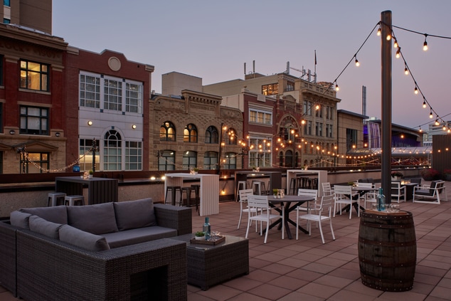 Rooftop patio with seating and lights