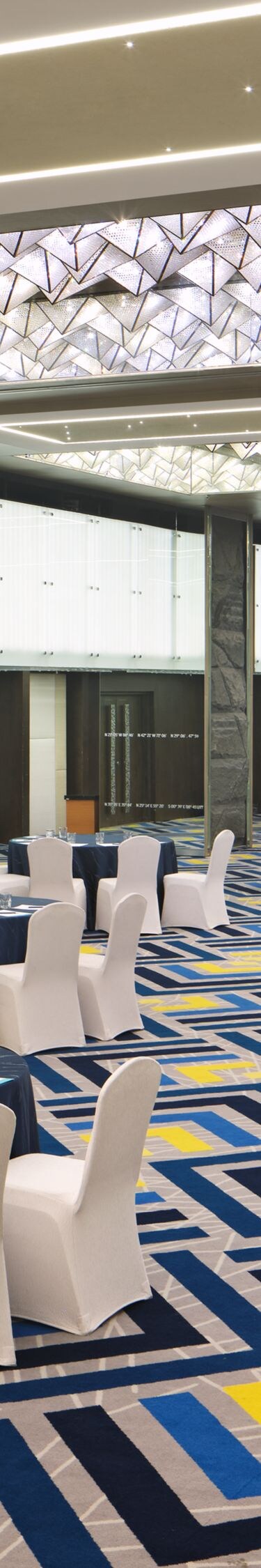 Ballroom with banquet setup and lighting