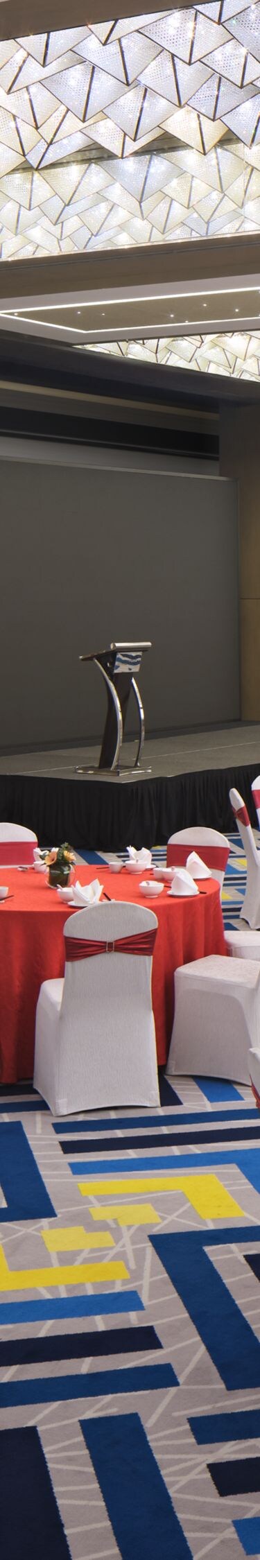 Ballroom with banquet setup and stage