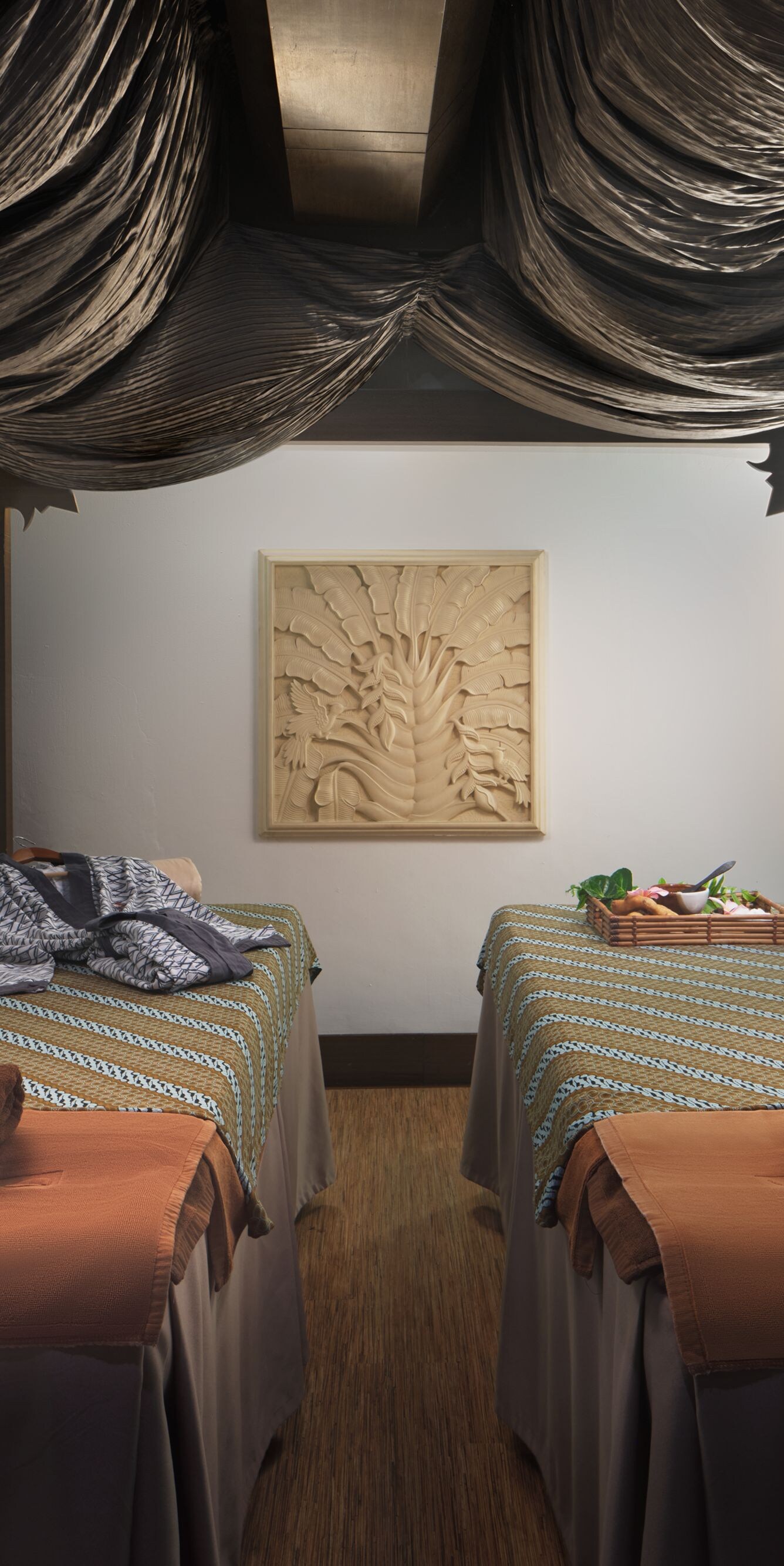 Spa room with two massage tables and decor