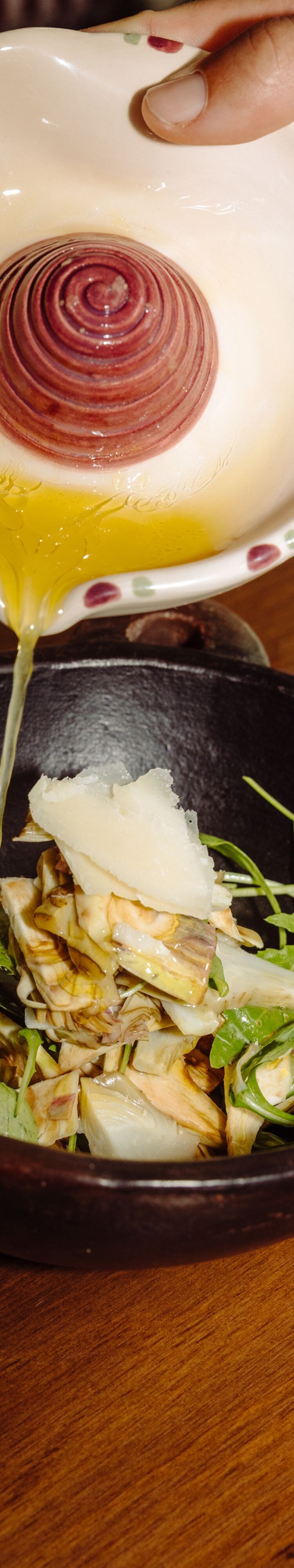 Olive oil poured on artichoke salad