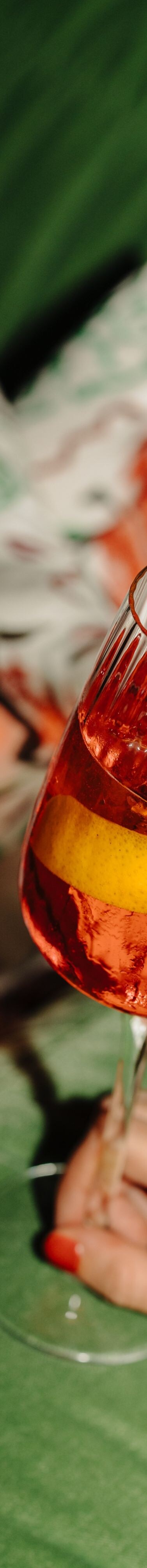 Spritz cocktail on green sofa