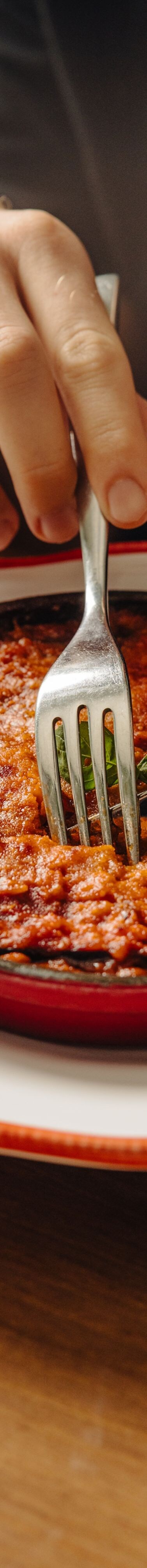 Guest serving baked pasta dish