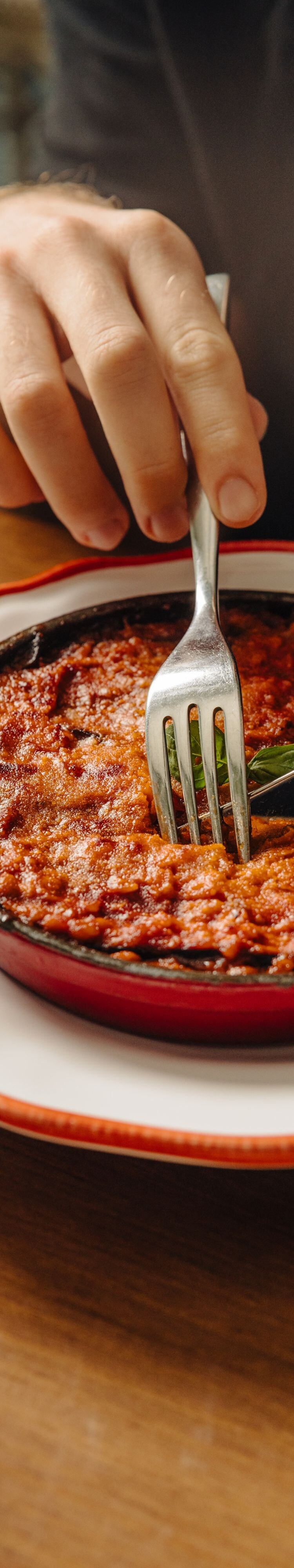 Guest serving baked pasta dish