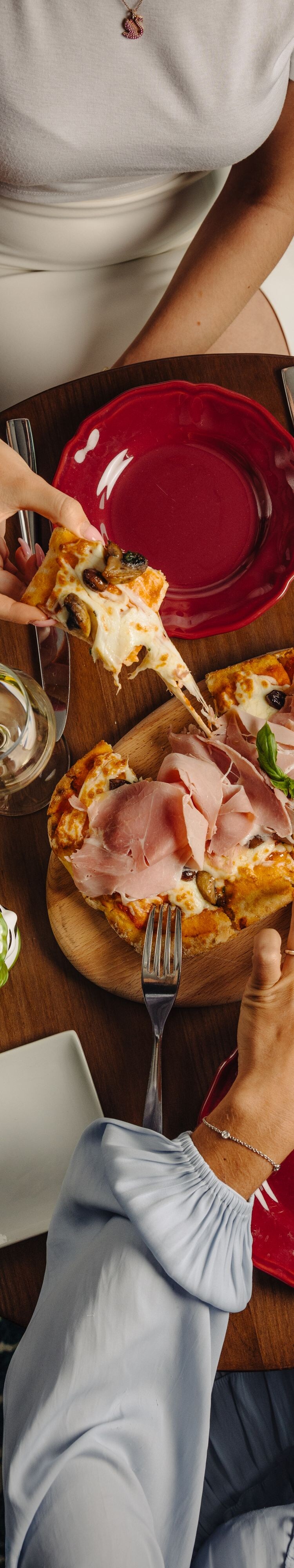 Guests sharing pizza at table