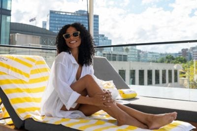 Guest relaxing beside the rooftop pool