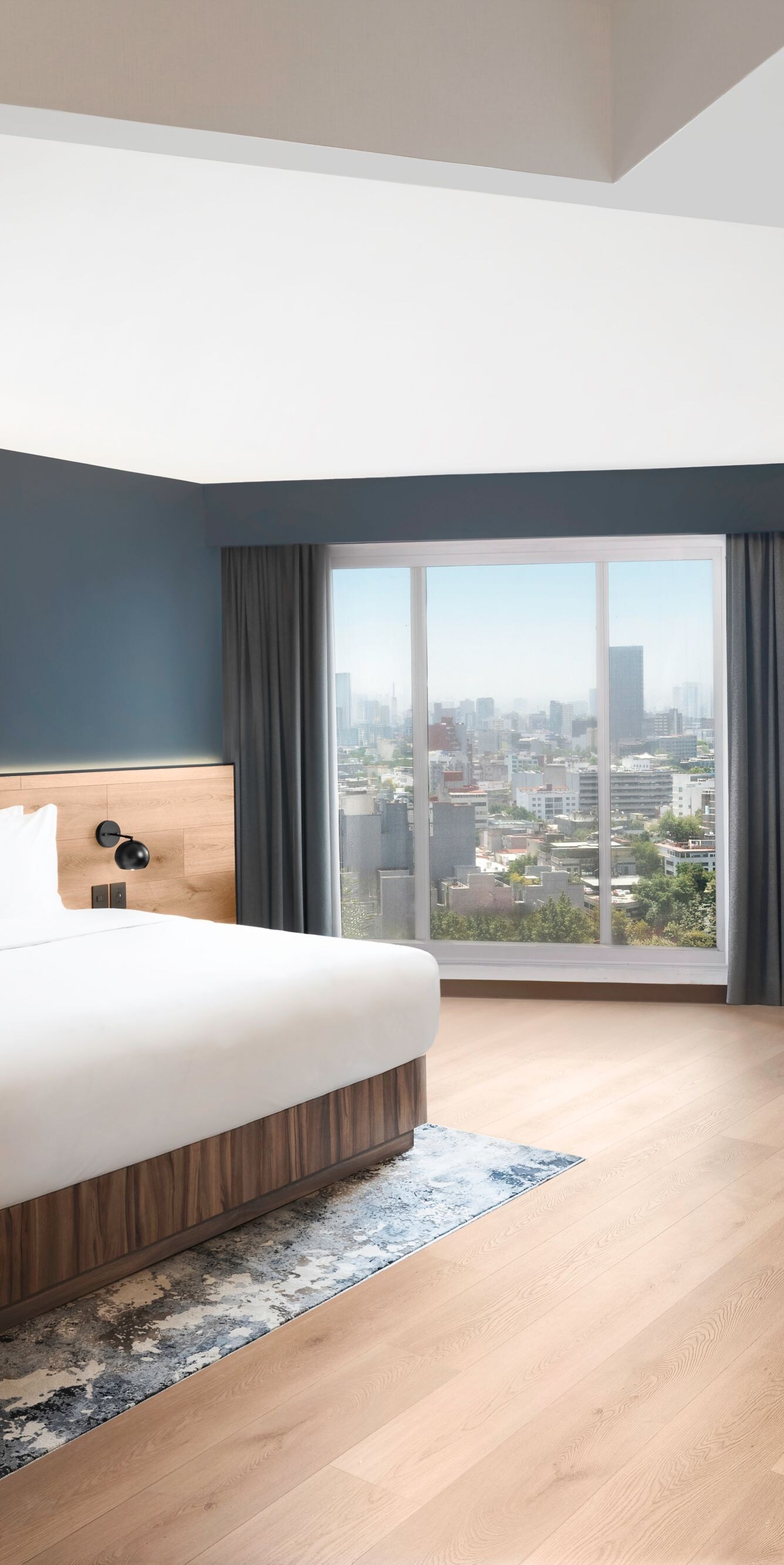 Modern bedroom with desk and city view