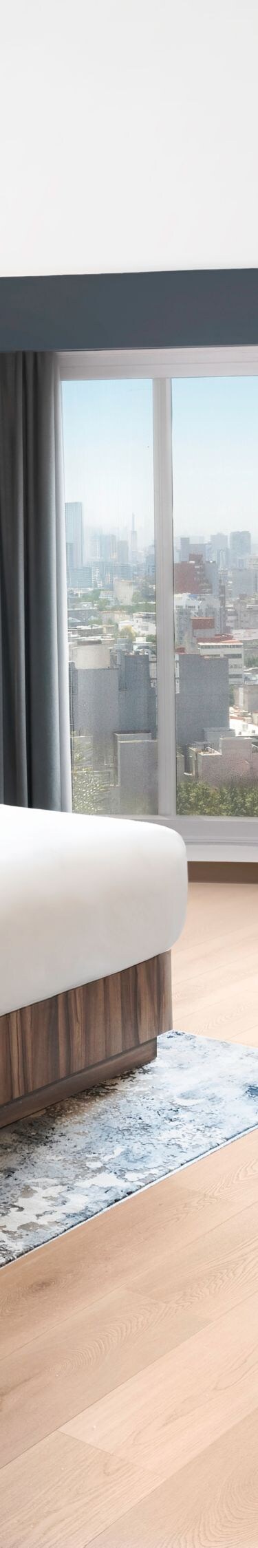 Modern bedroom with desk and city view