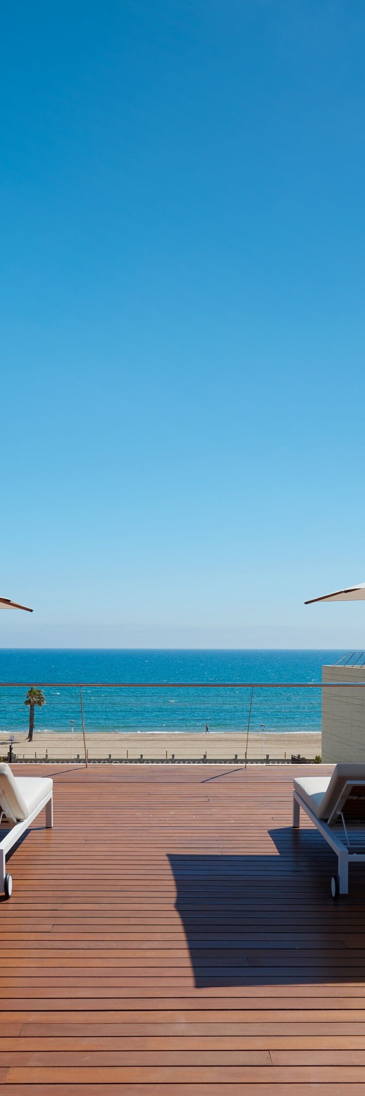 Outdoor spa terrace with sun loungers and cabanas.