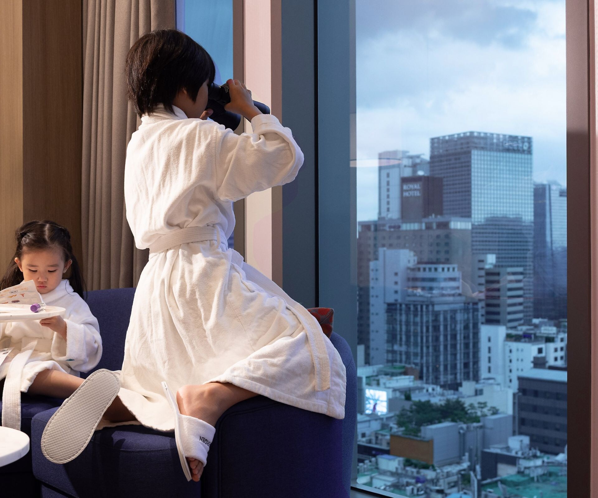 Children enjoying time together in guest room