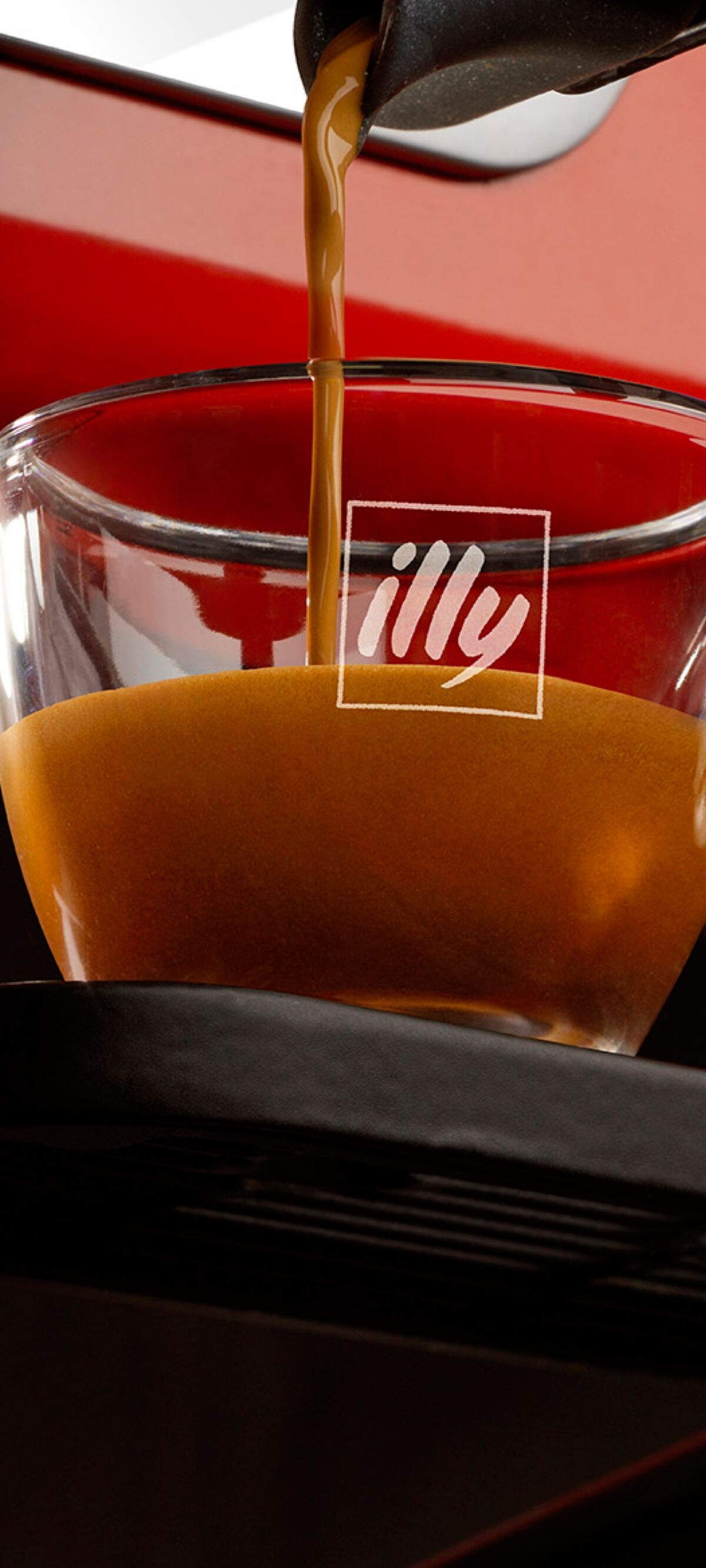 Fresh illy espresso being extracted