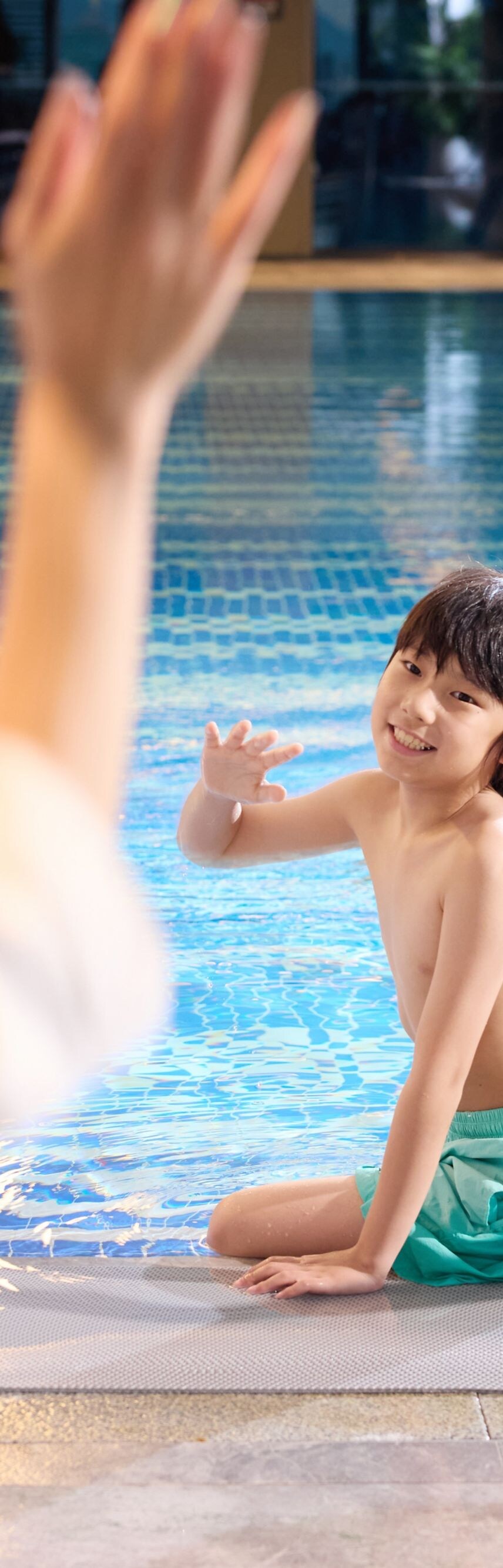 Family playing in the swimming pool